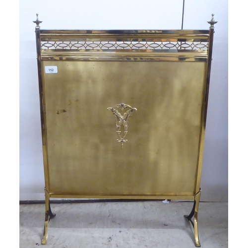 152 - A mid 20thC lacquered brass firescreen, raised on splayed feet  29