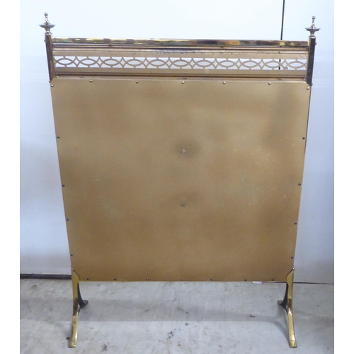 152 - A mid 20thC lacquered brass firescreen, raised on splayed feet  29