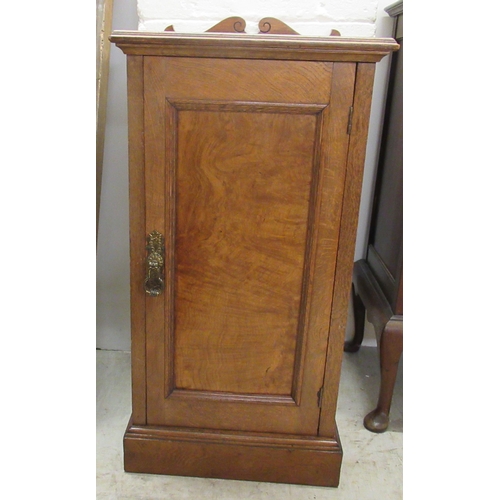 153 - A late Victorian oak and walnut pot cupboard, on a plinth  31