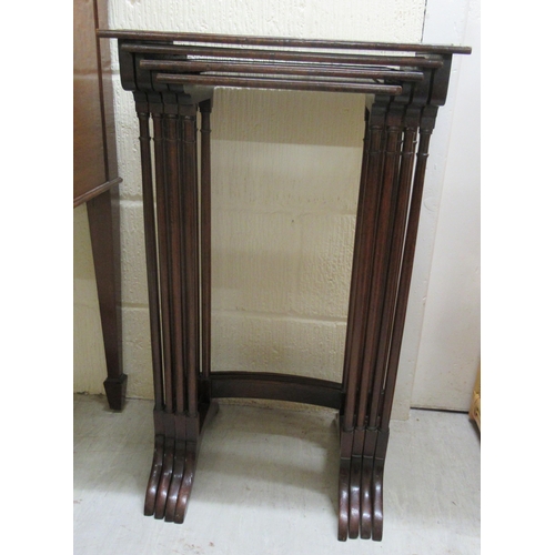 156 - An early 20thC quartetto of mahogany occasional tables, raised on turned pillar supports and splayed... 