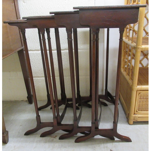 156 - An early 20thC quartetto of mahogany occasional tables, raised on turned pillar supports and splayed... 