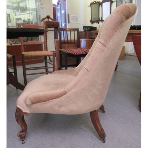 159 - A late Victorian fabric covered nursing chair, raised on floral, carved, cabriole forelegs