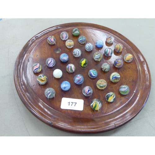 177 - A 20thC solitaire board with coloured and clear marbles  11