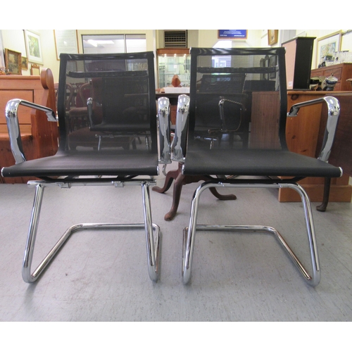 181 - A pair of modern chrome finished cantilever design chairs, each with a woven mesh material back and ... 