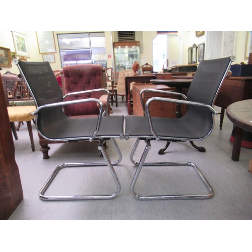 182 - A pair of modern chrome finished cantilever design chairs, each with a woven mesh material back and ... 