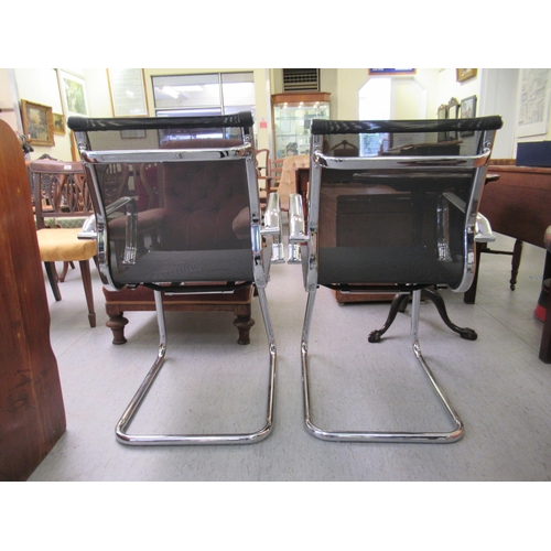 182 - A pair of modern chrome finished cantilever design chairs, each with a woven mesh material back and ... 