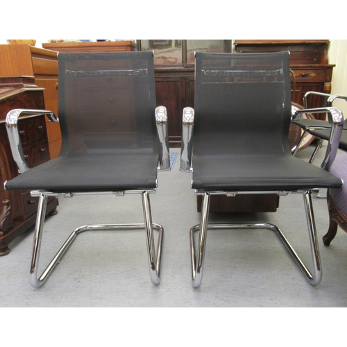 183 - A pair of modern chrome finished cantilever design chairs, each with a woven mesh material back and ... 