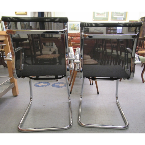 184 - A pair of modern chrome finished cantilever design chairs, each with a woven mesh material back and ... 