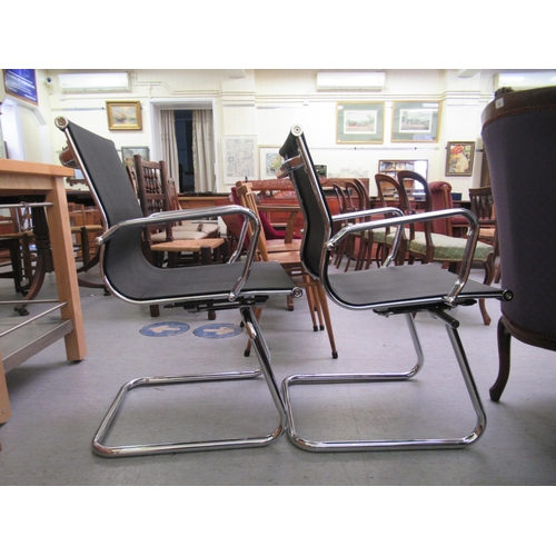 184 - A pair of modern chrome finished cantilever design chairs, each with a woven mesh material back and ... 