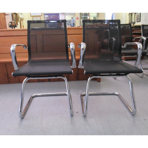 185 - A pair of modern chrome finished cantilever design chairs, each with a woven mesh material back and ... 