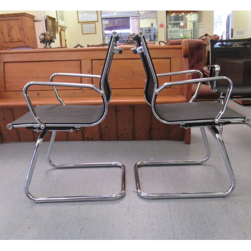 185 - A pair of modern chrome finished cantilever design chairs, each with a woven mesh material back and ... 