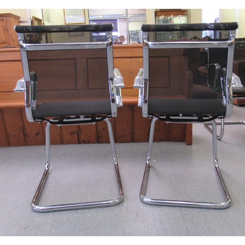 185 - A pair of modern chrome finished cantilever design chairs, each with a woven mesh material back and ... 