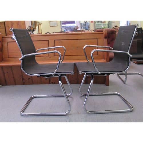 185 - A pair of modern chrome finished cantilever design chairs, each with a woven mesh material back and ... 