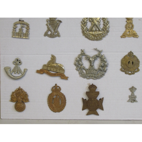 191 - Sixteen regimental cap badges and other insignia, some copies: to include the Royal Sussex; Inniskil... 