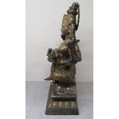 192 - A 20thC Asian patinated bi-coloured bronze Buddhist goddess with four arms, seated cross-legged, pla... 