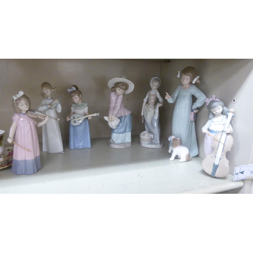 199 - Six Nao and one Lladro porcelain figures: to include girls playing musical instruments  largest 8