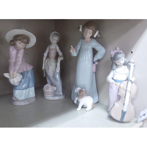 199 - Six Nao and one Lladro porcelain figures: to include girls playing musical instruments  largest 8