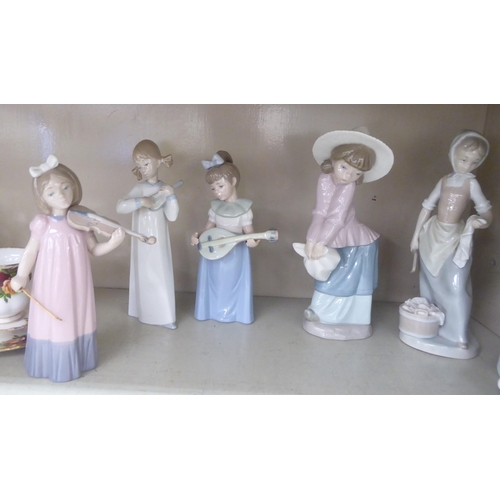 199 - Six Nao and one Lladro porcelain figures: to include girls playing musical instruments  largest 8