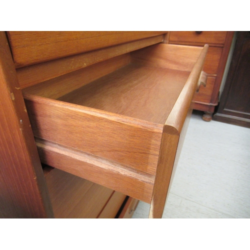 214 - A 1970s teak six drawer tallboy, on a plinth  39