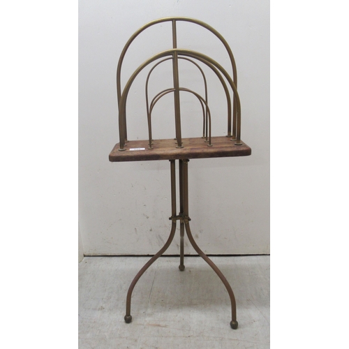 238 - A mid 20thC tubular framed, two division magazine rack, raised on splayed legs  32