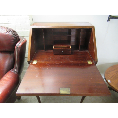 24 - A lady's 1930s mahogany bureau, the fall flap enclosing a fitted interior, over twin lopers and a sh... 