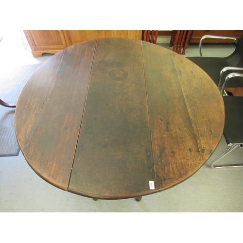 259 - A George III stained oak drop-leaf dining table, raised on bobbin turned and block supports  30