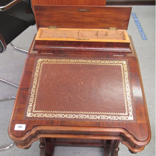 260 - A mid Victorian crossbanded mahogany and walnut Davenport with a hinged lidded compartment, over a t... 