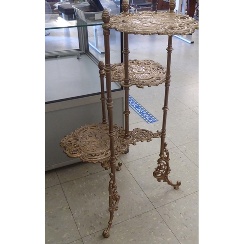 263 - A pair of modern cast metal, three tier cakestands, decorated with birds, c-scroll and foliate ornam... 