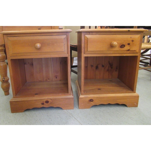 289 - A pair of modern pine bedside cabinets, each with a single drawer, over an open shelf, on a bracket ... 