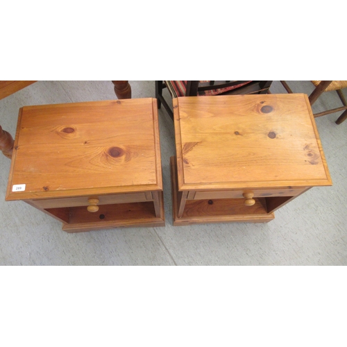 289 - A pair of modern pine bedside cabinets, each with a single drawer, over an open shelf, on a bracket ... 