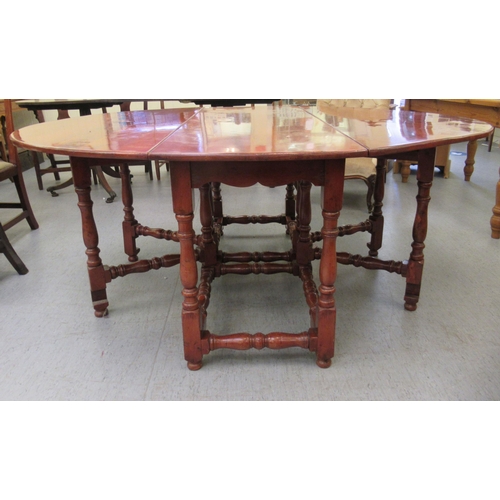 296 - A modern yewwood drop leaf/wake table, raised on turned baluster and block supports  29