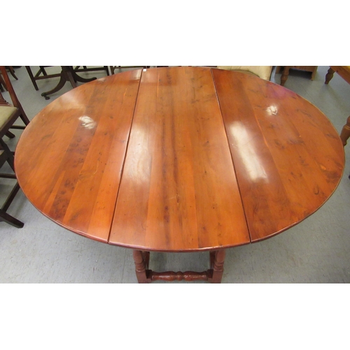 296 - A modern yewwood drop leaf/wake table, raised on turned baluster and block supports  29