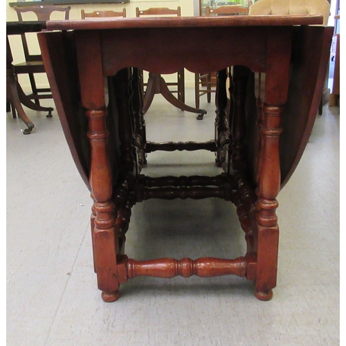 296 - A modern yewwood drop leaf/wake table, raised on turned baluster and block supports  29