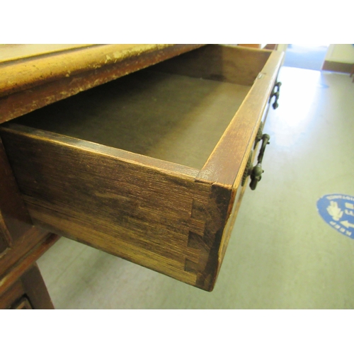 312 - A mid 20thC mahogany twin pedestal, nine drawer chest, raised on bracket feet  31