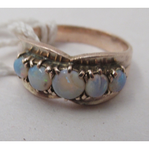 331 - A yellow metal ring, set with five graduated opals