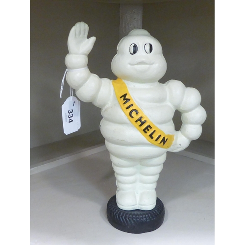 334 - A cast iron money box, The Michelin Man  9