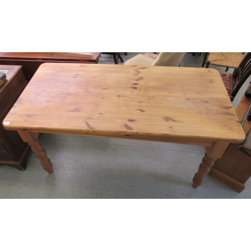 48 - A modern pine refectory table, the one piece top with rounded corners, raised on tapered legs  31