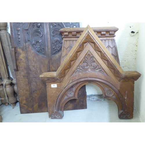 65 - Late 19th/early 20thC wooden architectural salvage: to include a carved pitch pine Gothic arch  24