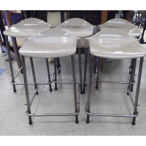 74 - A stacking set of five Steelux GLC design stools with moulded grey plastic seats and painted metal f... 