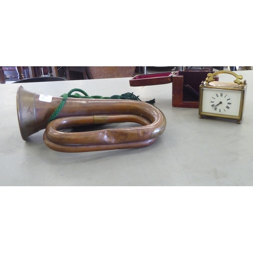 80 - A Henry Potter & Co military copper bugle; and an early 20thC lacquered brass carriage clock, fa... 