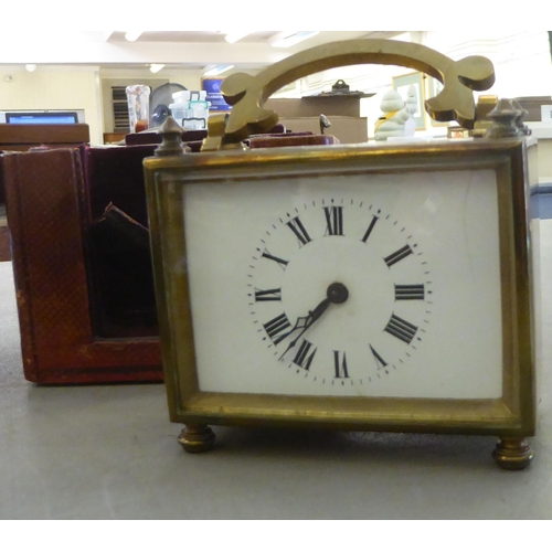 80 - A Henry Potter & Co military copper bugle; and an early 20thC lacquered brass carriage clock, fa... 