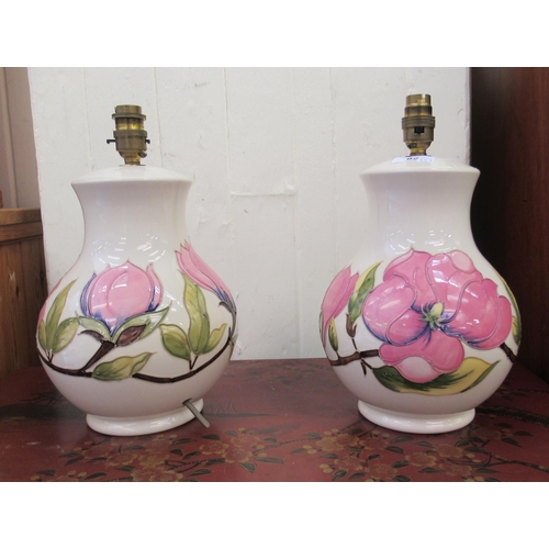 82 - A pair of Moorcroft pottery table lamps, decorated in relief in pastel tones with flora  12