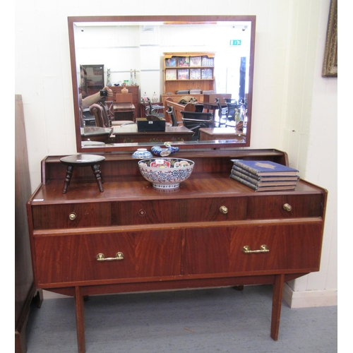 91 - A mid 20thC teak dressing table, surmounted by a mirror, over three frieze drawers, over two long dr... 