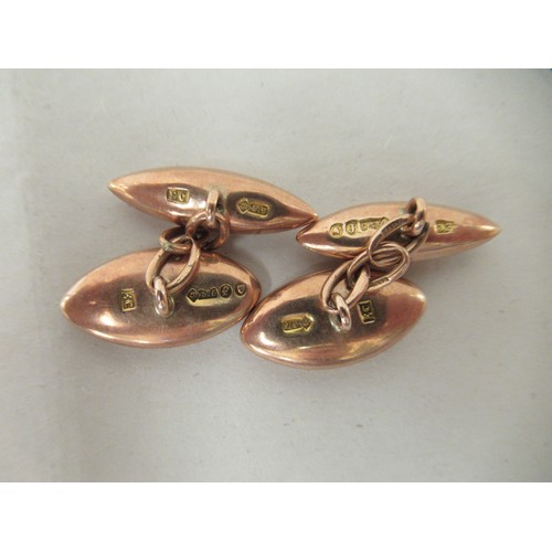 281 - A pair of 9ct gold cufflinks, on chains with engraved ornament