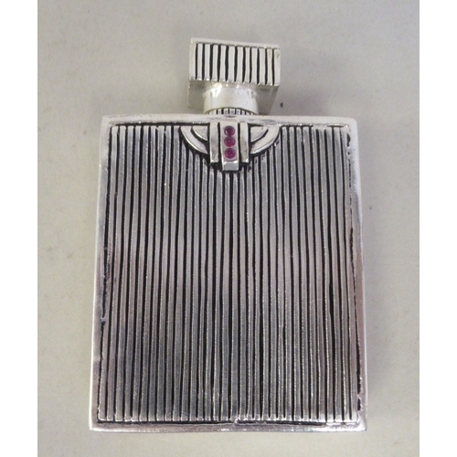 35 - An Art Deco style white metal and enamel, rectangular perfume bottle, featuring an American glamour ... 