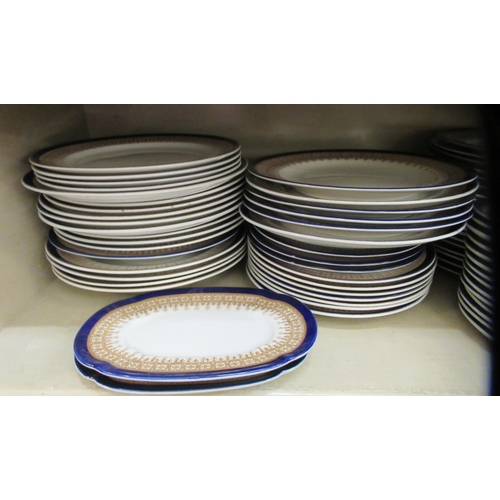 102 - A Royal Worcester porcelain china dinner service, decorated with a blue bands and gilt highlights