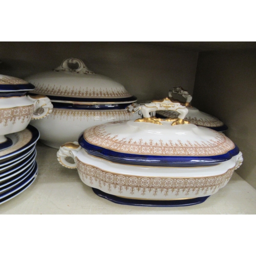 102 - A Royal Worcester porcelain china dinner service, decorated with a blue bands and gilt highlights