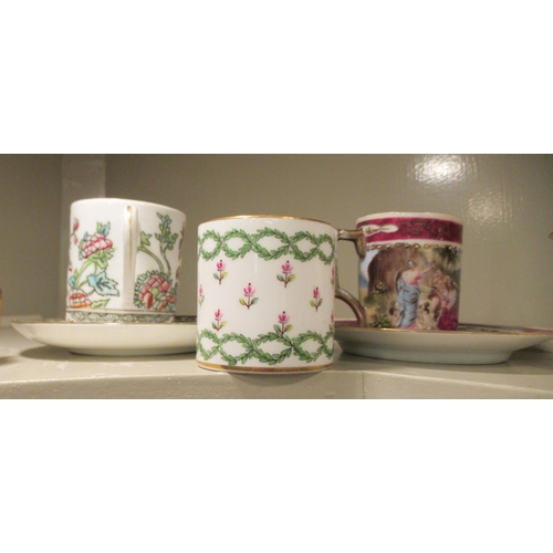 104 - Decorative china cabinet cups and saucers: to include a Royal Worcester example  with fruiting trees... 