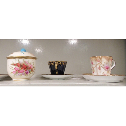 104 - Decorative china cabinet cups and saucers: to include a Royal Worcester example  with fruiting trees... 