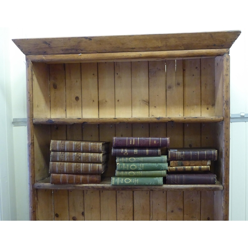 20 - A late 19thC waxed pine dresser, the upper part with open shelves, over a twin drawer cupboard base ... 